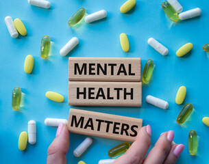 Mental Health Matters symbol. Concept words Mental Health Matters on wooden blocks. Beautiful blue...