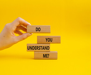 Do you understand me symbol. Concept words Do you understand me on wooden blocks. Beautiful yellow background. Businessman hand. Business and Do you understand me concept. Copy space.