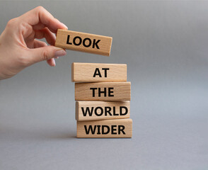 Look at the world wider symbol. Wooden blocks with words Look at the world wider. Beautiful grey...