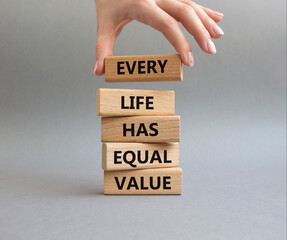 Equality symbol. Wooden blocks with words Every Life has Equal Value. Businessman hand. Beautiful...