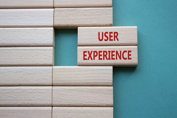 User Experience symbol. Concept word User Experience on wooden blocks. Beautiful grey green...