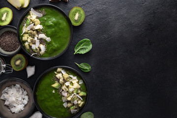 Delicious and healthy green smoothie bowls made with fresh ingredients spinach, avocado, kiwi,...