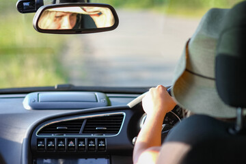 driver driving in hat  a car on the road