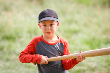 A Happy child with baseball bat on nature concept in park