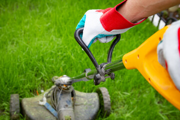 A man and lawnmower grass in the garden