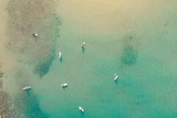 Aerial view by drone of people practicing Stand Up Paddle or SUP in Mediterranean turquoise clear...