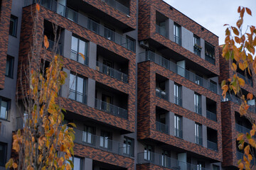 Modern residential building exterior and autumn trees, European contemporary architecture