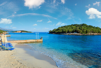 Beautiful Ionian Sea with clear turquoise water and morning summer coast view from beach (Ksamil,...