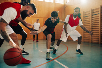 Professional basketball team dribbling the ball and training defense and attack