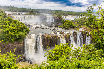 Iguazu falls waterfall in Argentina and Brazil border on the river Iguazu. Tropical landscape with...