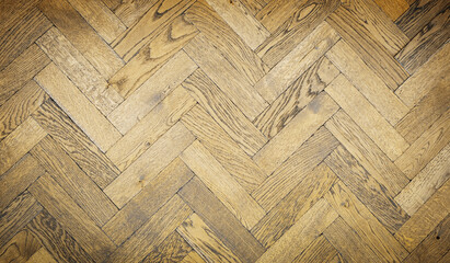 Herringbone wood tile pattern on a floor or wall with antique finish