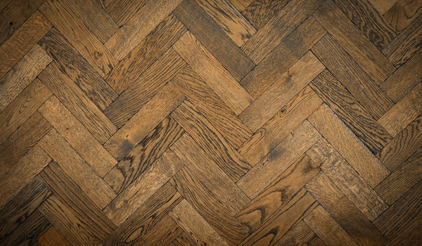 Herringbone wood tile pattern on a floor or wall with antique finish