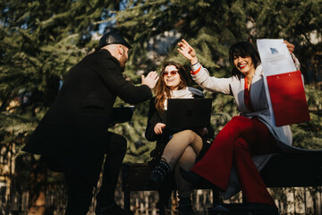 Multicultural team of young business entrepreneurs celebrating a successful idea in an outdoor...