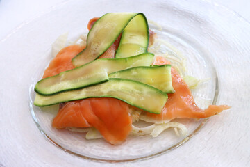 Smoked salmon with grilled courgettes and sliced ​​fennel. Italian gourmet cuisine