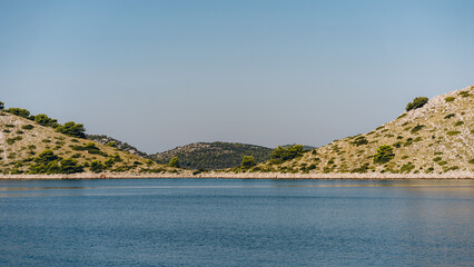 Relaxing seascape with blue sea water, dry hills of Dugi Otok island in Adriatic Sea, Croatia