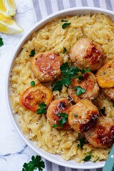 Baked lemon butter chicken meatballs with creamy orzo.top veiw