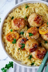 Baked lemon butter chicken meatballs with creamy orzo.top veiw