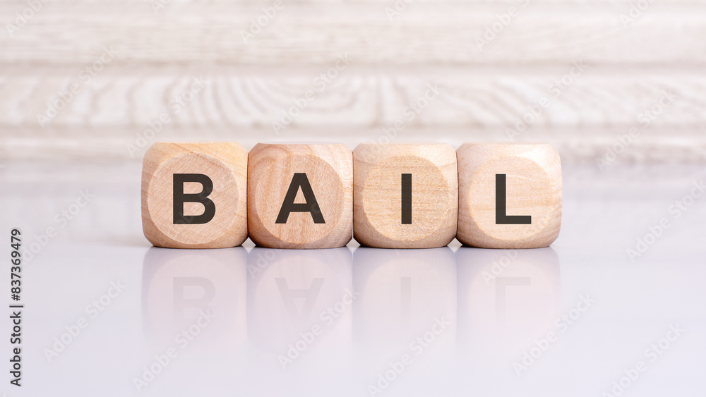 Poster the word bail is written on a wooden blocks structure. blocks on a bright gray background. selective