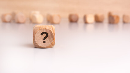 A mysterious wooden rectangle with a question mark engraved on it
