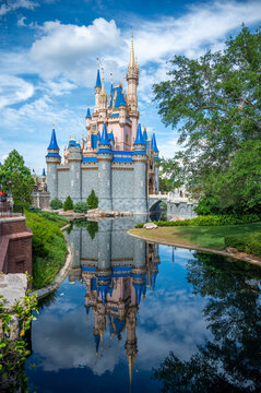 Side view of Cinderella castle in Disney World with a water reflection