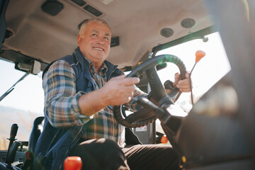 Navigating the Land Senior Farmer Directs Tractor Across Field © Alexandr