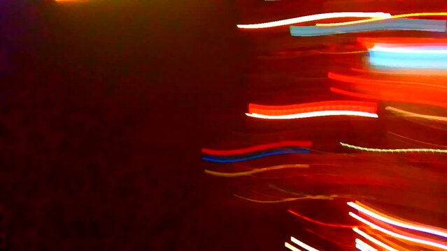 Chaotic movement of spots of all colors. Bright colors. Night city lights. Screensaver. Video art graphics.
