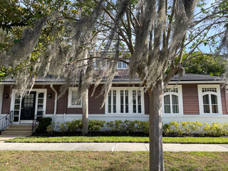 Vintage building white trim windows brown wooden exterior