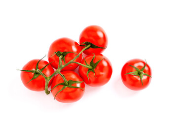 Branch of natural juicy tomatoes on a white background,  selective focus