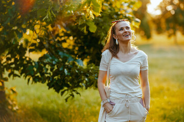 smiling young 40 years old woman in white shirt with tote bag