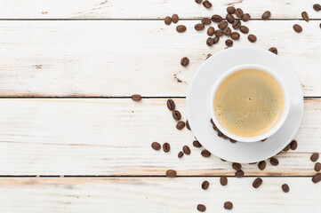 Cup of coffee on wooden background, top view