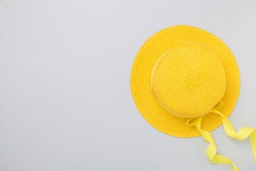 Yellow hat on color background, top view. Summer concept