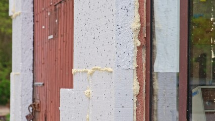 Thick Styrofoam Board used for Thermal Insulation of Old Residential Building External Wall during Themal Modernization for Compliance with European Green Deal Regulations