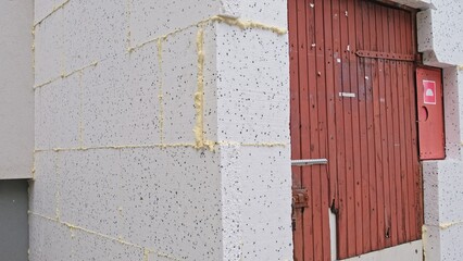 Thick Styrofoam Board used for Thermal Insulation of Old Residential Building External Wall during Themal Modernization for Compliance with European Green Deal Regulations