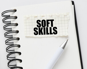 SOFT SKILLS on a piece of paper placed on the notebook. Concept for business.