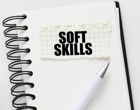 SOFT SKILLS on a piece of paper placed on the notebook. Concept for business.