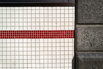 Vintage tiles and stonework on an exterior wall of an old building