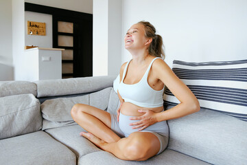 Pregnant Female At Home Doing Prenatal Yoga. Home Yoga Practice In Pregnancy. Future Mother...