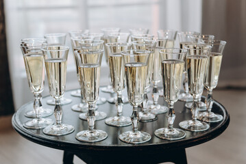 row of champagne glasses on buffet table