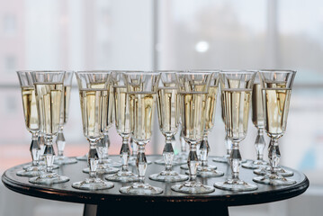 row of champagne glasses on buffet table