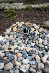 New installation of storm water flood management, round outflow pipe leading to a flow of river...