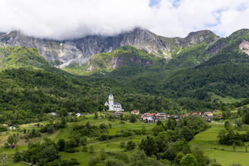 San Fermin Church immersed in the green of the Slovenian mountains a few steps from Caporetto. It remains a precious gem of Christianity and faith to be admired, makes the view of the mountain unique.