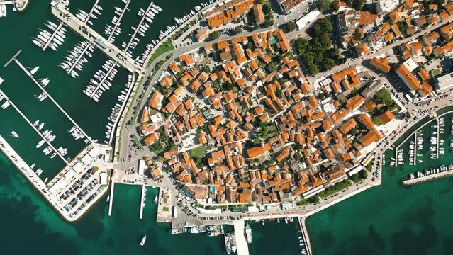 Biograd na Moru, aerial above marina view with ships and yachts at pier in row. Old European architecture in summer port, travel destination on Adriatic Sea coast, Dalmatia region of Croatia