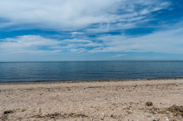 Trumans Beach in the Hamptons, Long Island, showcases serene summer views with its pebbly shoreline and clear blue waters. Ideal for relaxation and picturesque landscapes, perfect for capturing the es