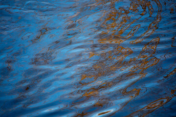 Close-up of a river with reflection of autumn colors