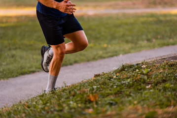 Sport running man in cross country trail run.