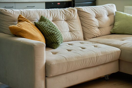 Sofa with decorative pillows in living room setting. Place for relaxation. Modern apartment interior