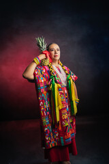 Fototapeta premium A woman wearing a colorful dress holding a pineapple