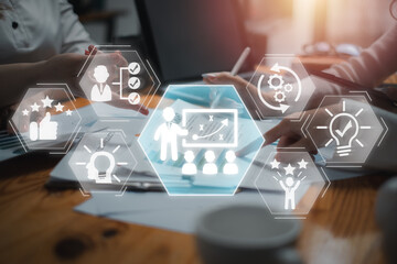 Coaching concept, Business team analyzing income charts and graphs on desk with Coaching icon on virtual screen.