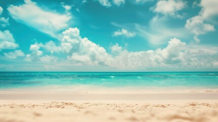 Abstract blur defocused background. Tropical summer beach with golden sand, turquoise ocean and blue sky with white clouds on bright sunny day. Colorful landscape for summer holidays