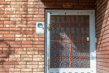 The elaborate and original metal work of a door grille, of a brick house in the town of Arcabuco,...